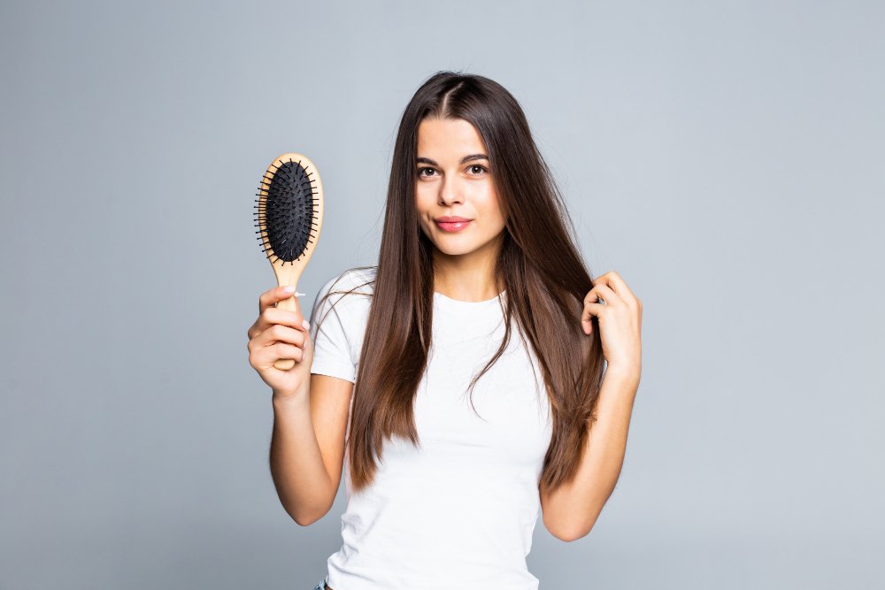 woman combing her hair isolated white